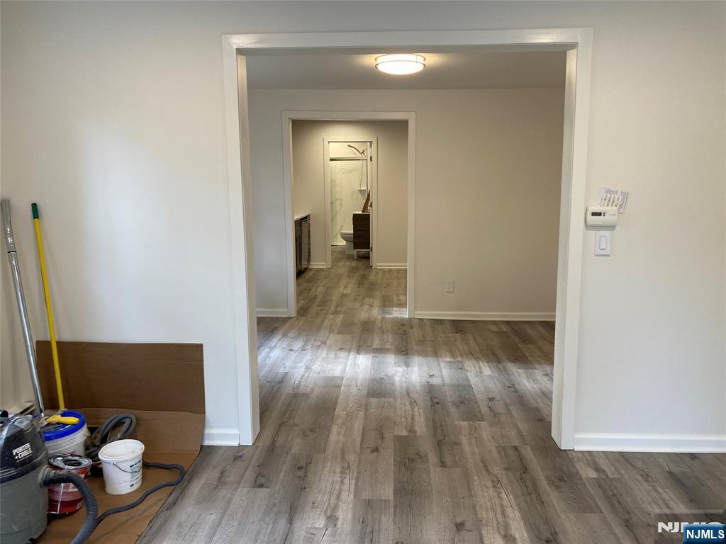 118 Doremus Avenue, Unit C Ridgewood, NJ 07450 - Photo 9 of 16 a view of a room with wooden floor and chair