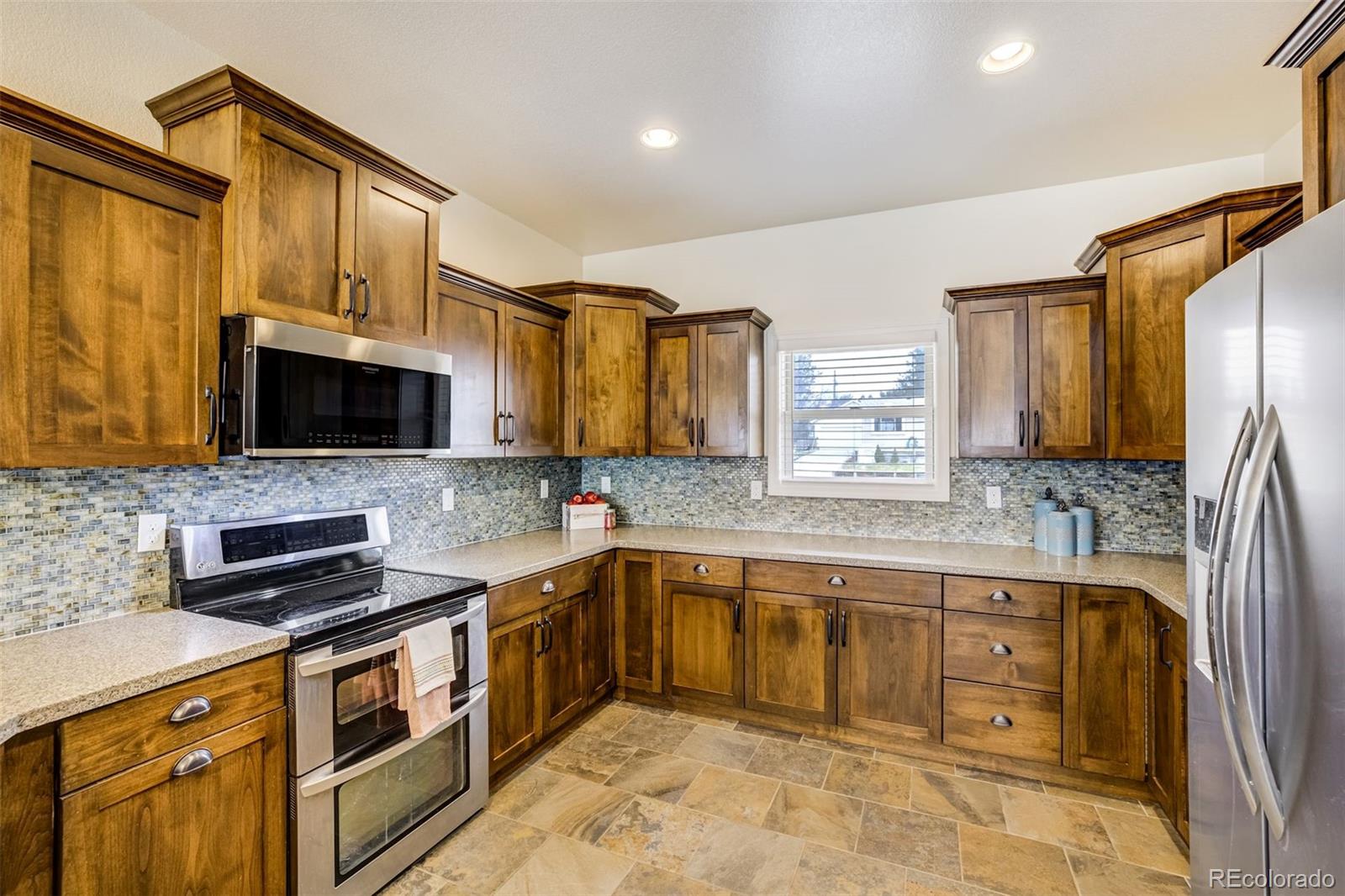 675 9th Street Limon, CO 80828 - Photo 2 of 49 a kitchen with stainless steel appliances a stove sink microwave and cabinets