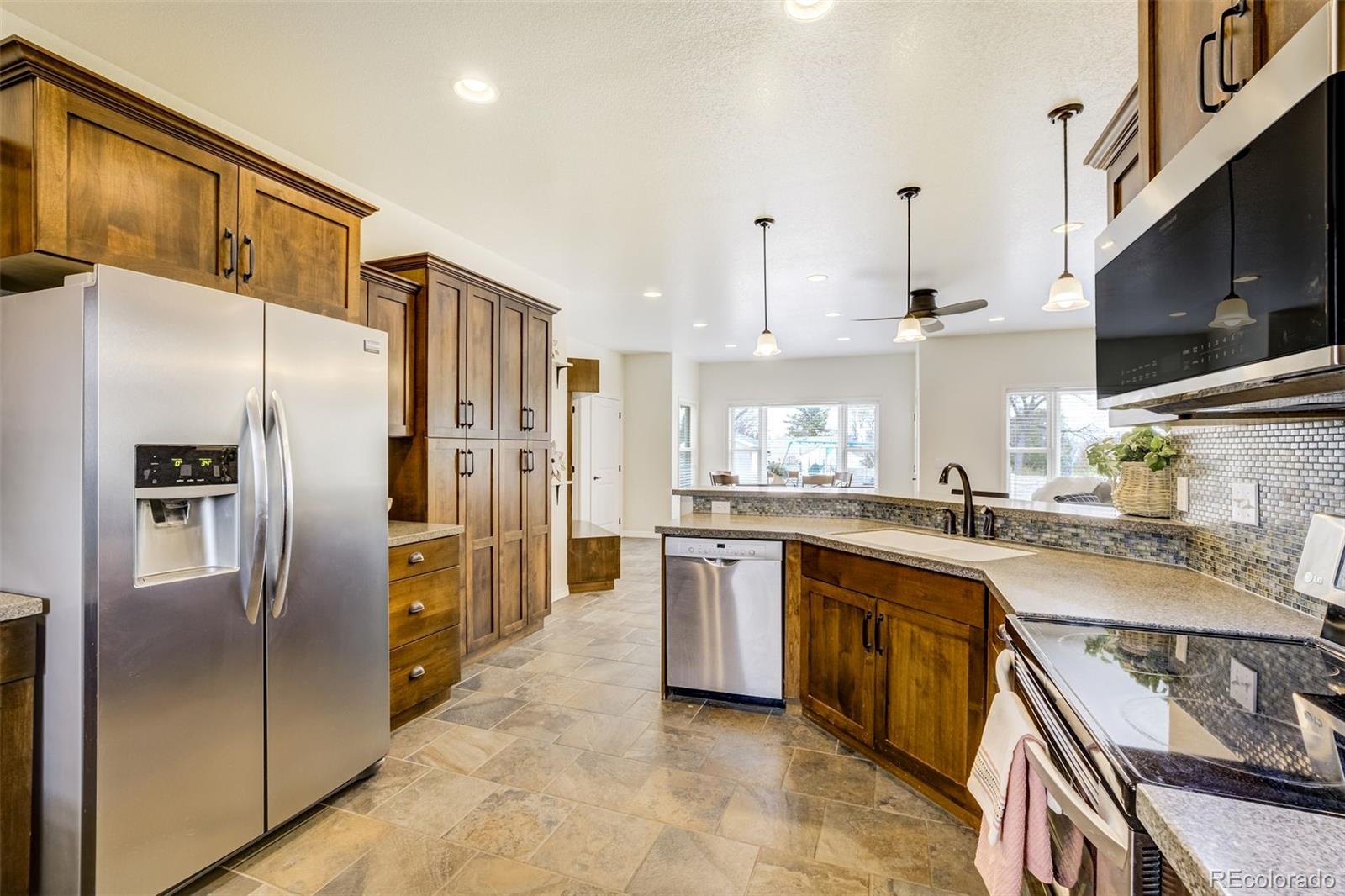675 9th Street Limon, CO 80828 - Photo 23 of 49 a kitchen with stainless steel appliances granite countertop a sink a stove a refrigerator and cabinets