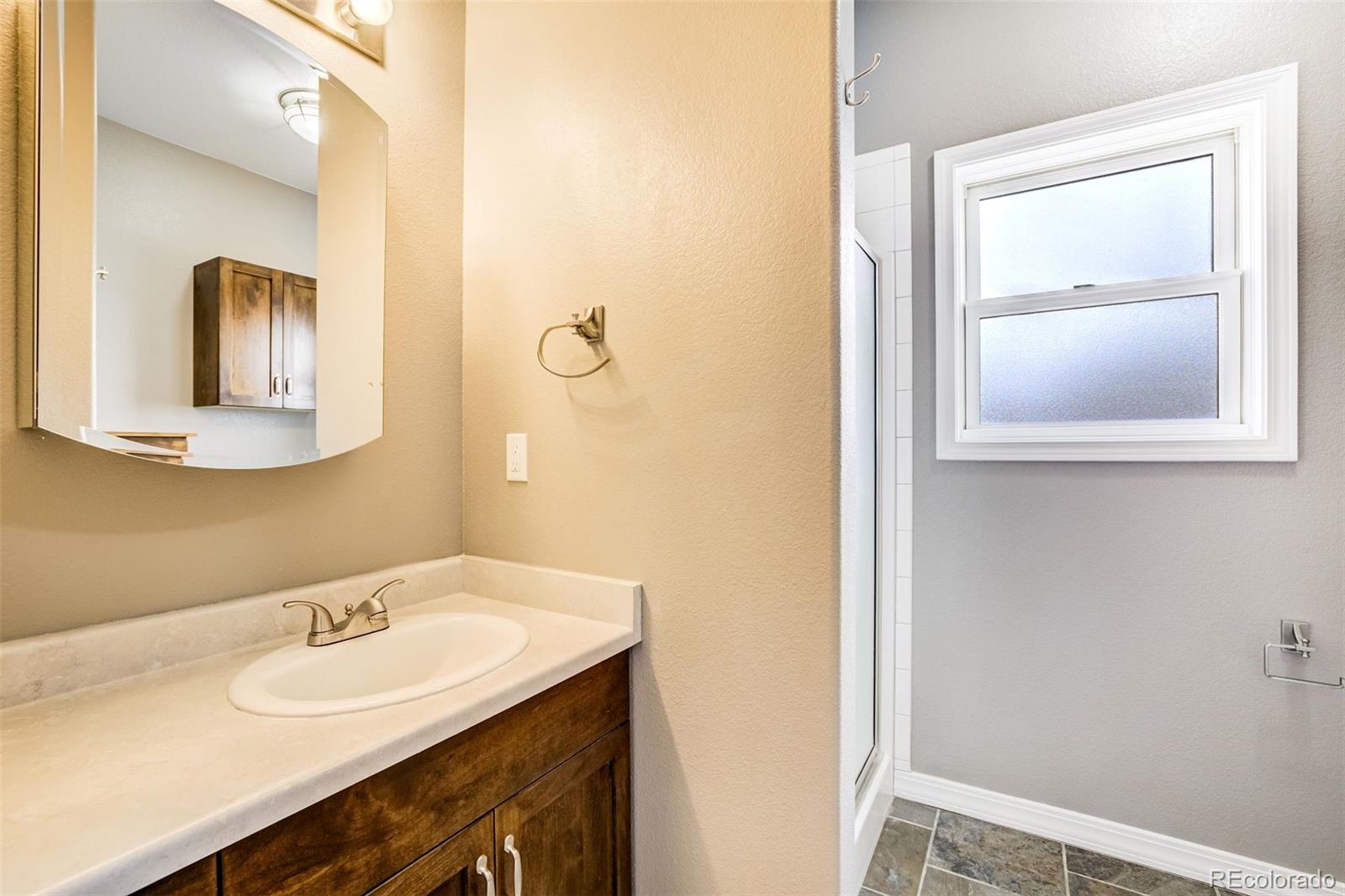 675 9th Street Limon, CO 80828 - Photo 26 of 49 a bathroom with a sink and a mirror