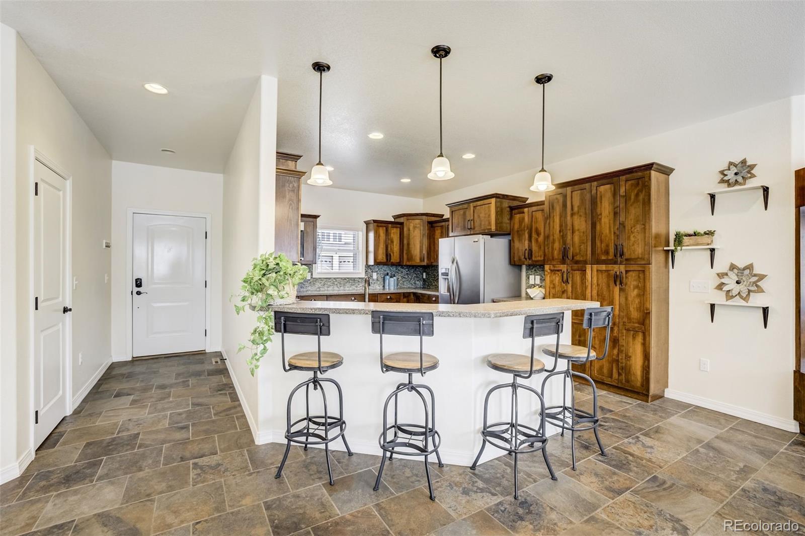 675 9th Street Limon, CO 80828 - Photo 4 of 49 a view of kitchen with stainless steel appliances kitchen island granite countertop dining table chairs and a rug