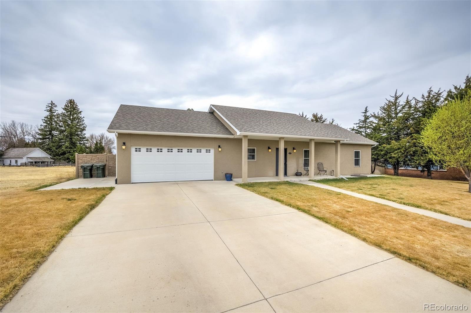 675 9th Street Limon, CO 80828 - Photo 41 of 49 a front view of a house with a yard and garage
