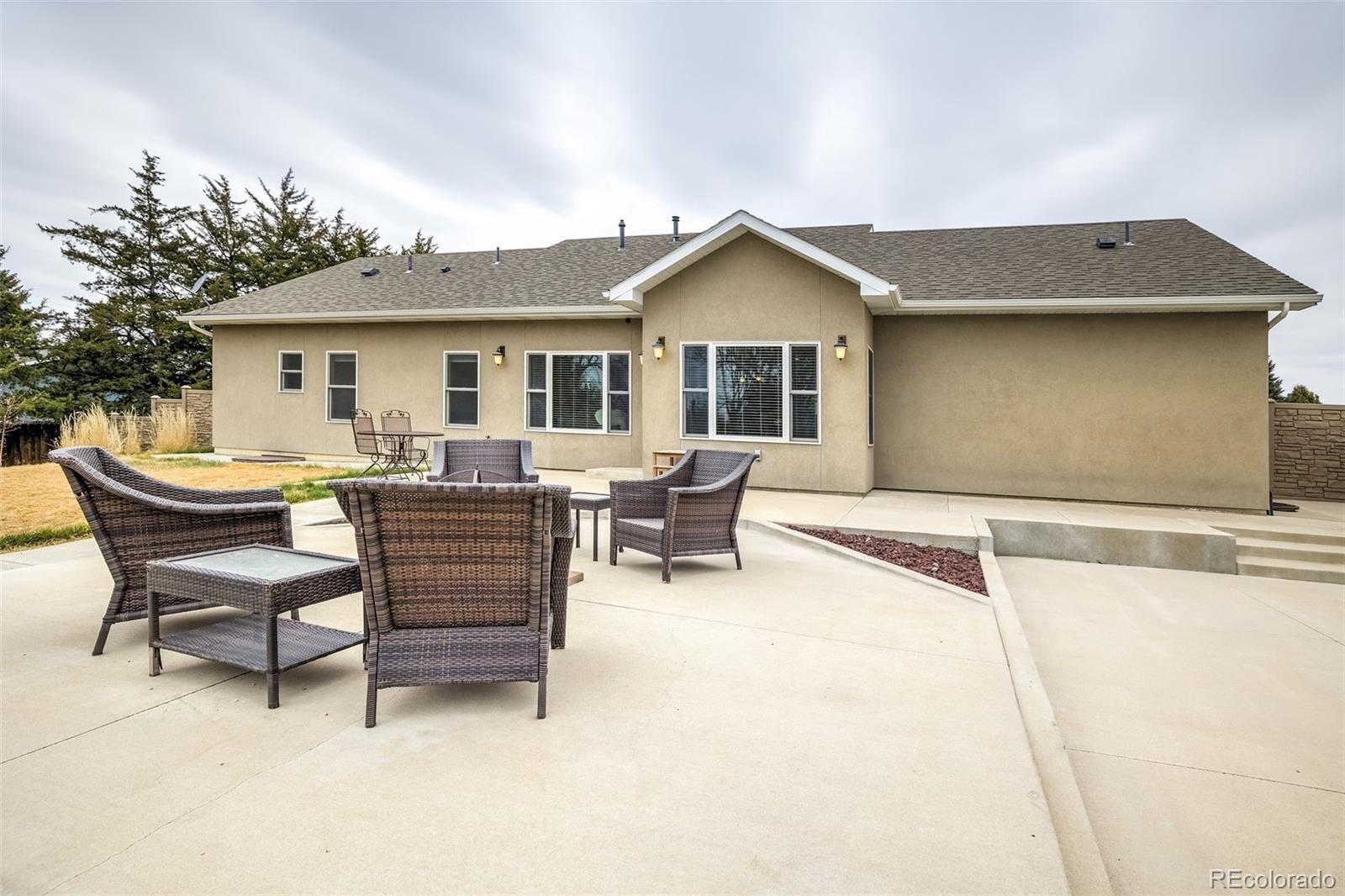 675 9th Street Limon, CO 80828 - Photo 7 of 49 a view of a house with a patio and a yard