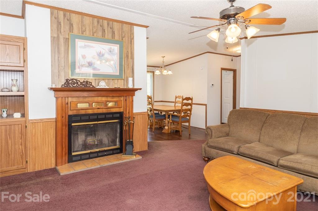 340 Old Bridge Road Rocky Point, NC 28457 - Photo 12 of 35 a living room with furniture a flat screen tv and a fireplace