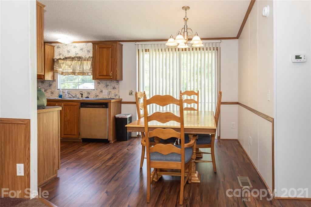 340 Old Bridge Road Rocky Point, NC 28457 - Photo 14 of 35 a view of a dining room with furniture window and wooden floor