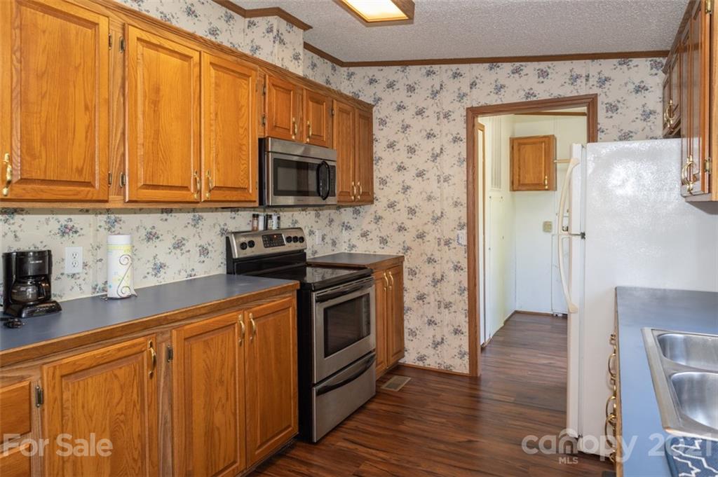 340 Old Bridge Road Rocky Point, NC 28457 - Photo 16 of 35 a kitchen with stainless steel appliances a stove a microwave a sink and cabinets