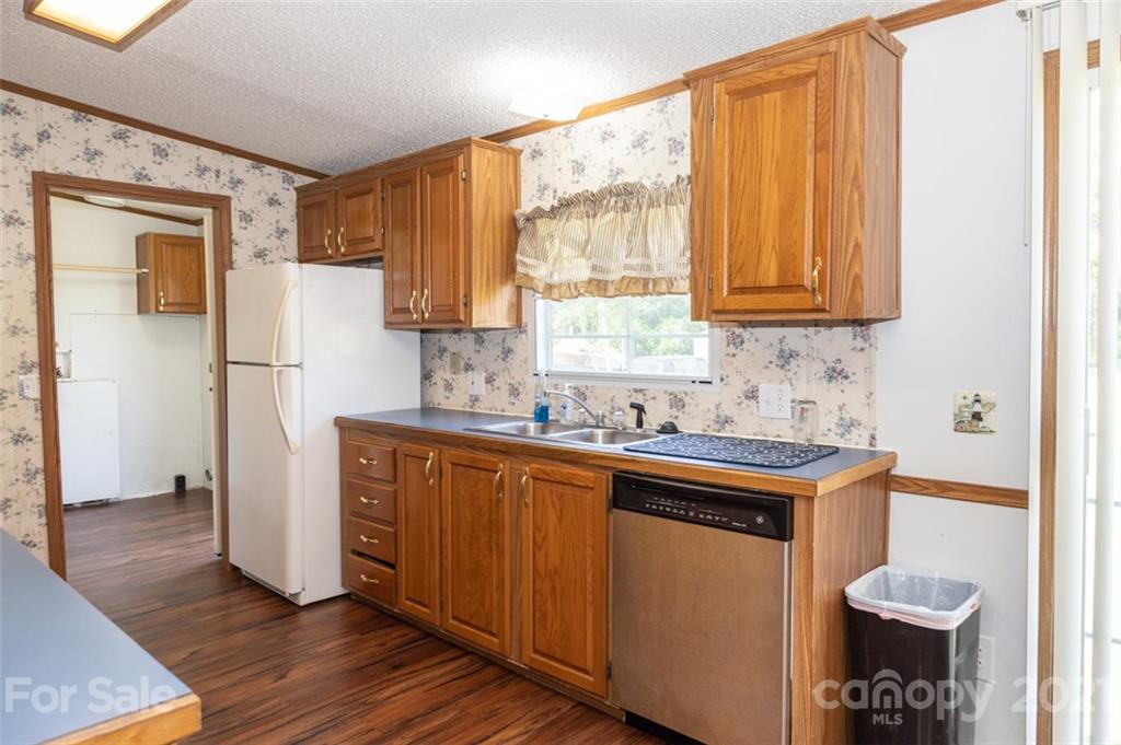 340 Old Bridge Road Rocky Point, NC 28457 - Photo 17 of 35 a kitchen with a refrigerator a sink and a window