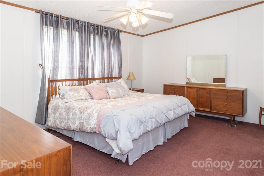340 Old Bridge Road Rocky Point, NC 28457 - Photo 18 of 35 a bedroom with a bed and a cabinets