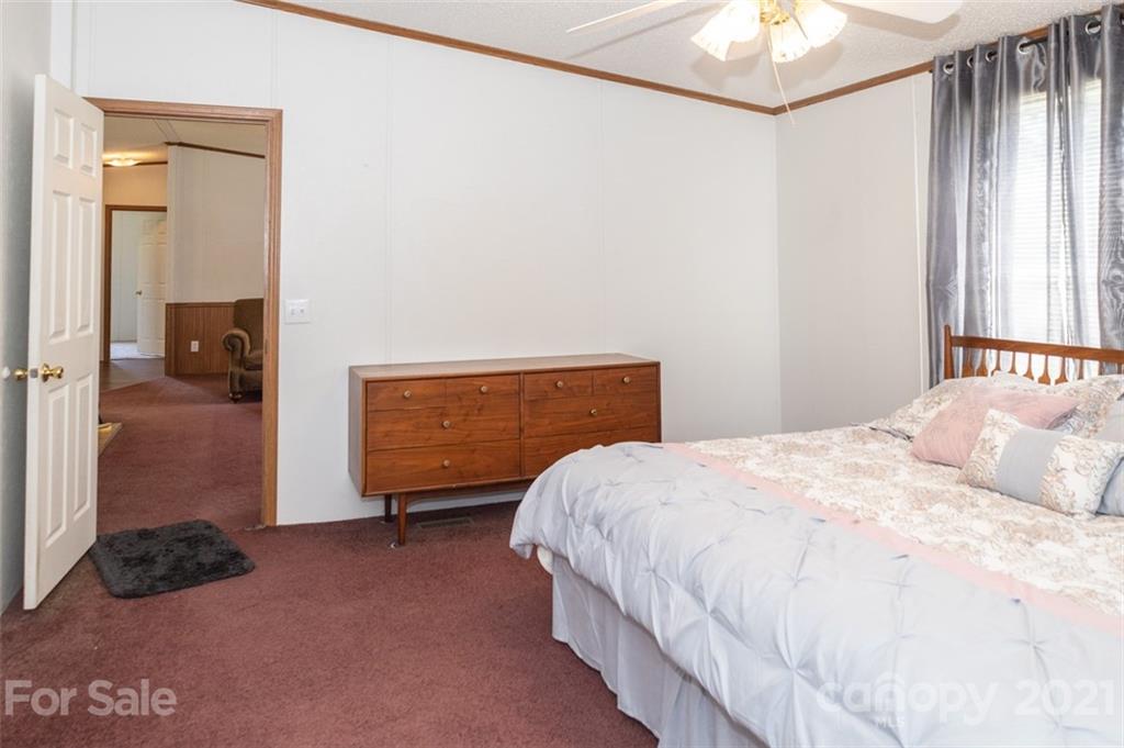 340 Old Bridge Road Rocky Point, NC 28457 - Photo 19 of 35 a bedroom with a bed and a painting on the wall