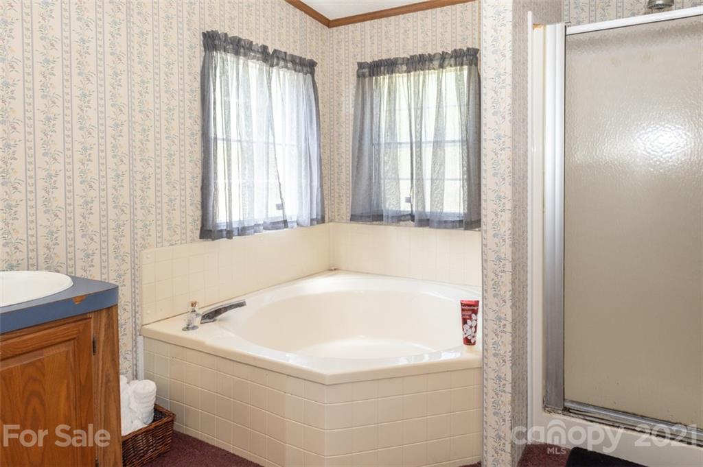 340 Old Bridge Road Rocky Point, NC 28457 - Photo 20 of 35 a white bath tub sitting in a bathroom next to a window