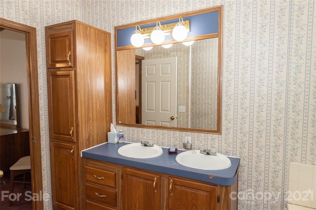 340 Old Bridge Road Rocky Point, NC 28457 - Photo 22 of 35 a bathroom with a granite countertop sink and a mirror