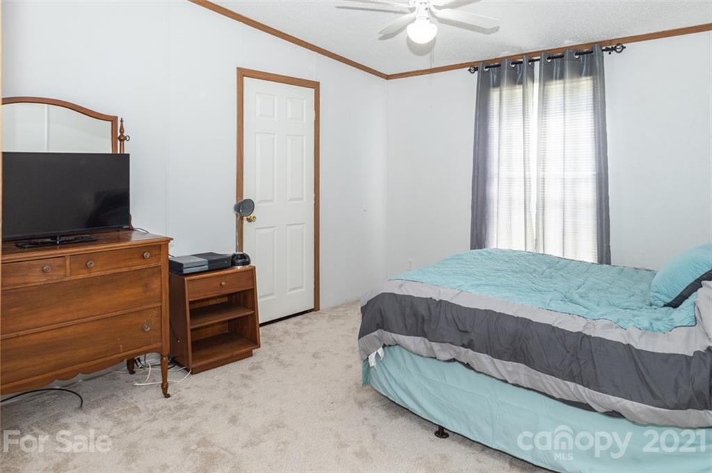 340 Old Bridge Road Rocky Point, NC 28457 - Photo 27 of 35 a bedroom with a bed and a flat screen tv