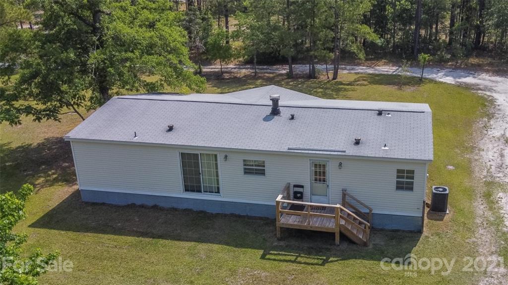 340 Old Bridge Road Rocky Point, NC 28457 - Photo 33 of 35 a aerial view of a house with swimming pool and a yard