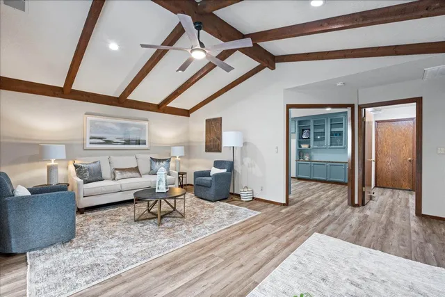 a living room with furniture and a wooden floor