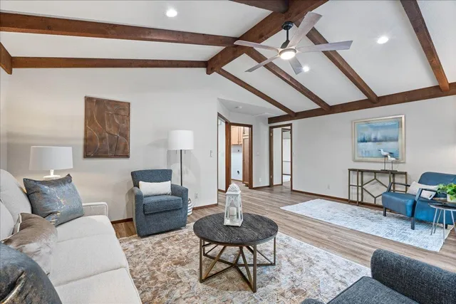 a living room with furniture and a wooden floor