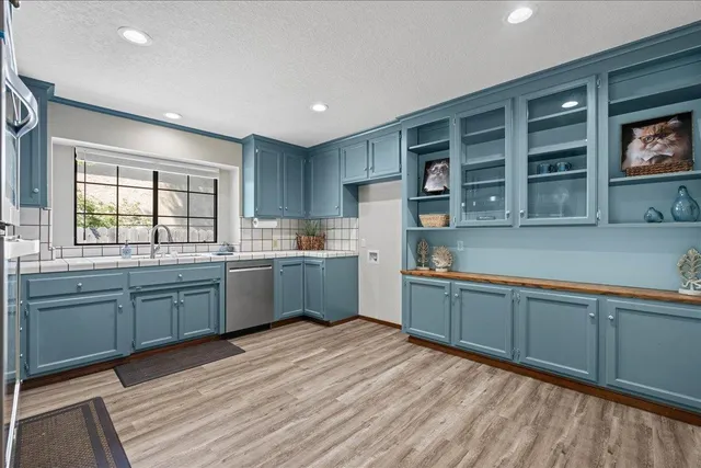 a kitchen with stainless steel appliances granite countertop a sink and cabinets
