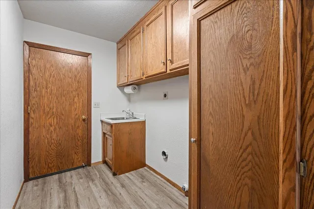 a view of a hallway with wooden floor and entryway