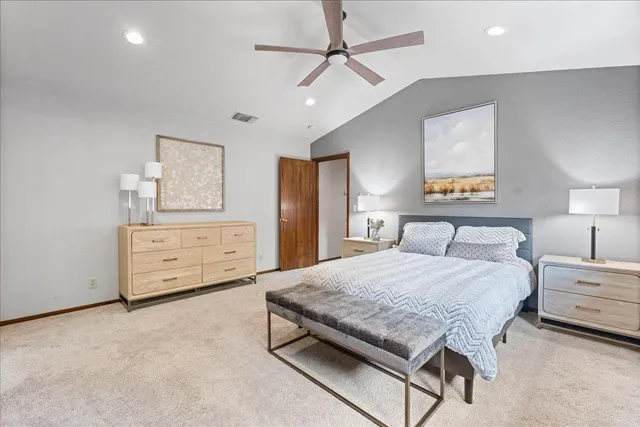 a spacious bathroom with a toilet a sink a mirror a shower and vanity