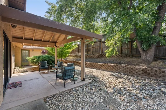 a view of a house with backyard porch and sitting area
