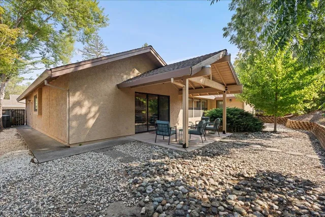 a view of a patio with table and chairs under an umbrella