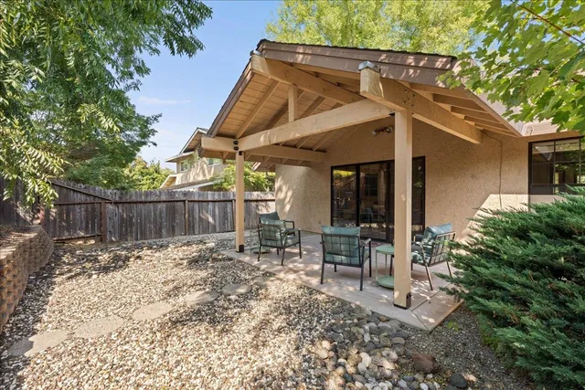 a view of a backyard with wooden fence