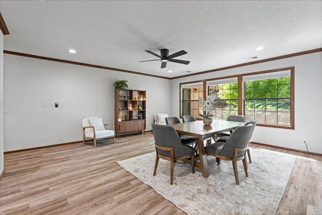 a dining room with furniture a rug and a large window