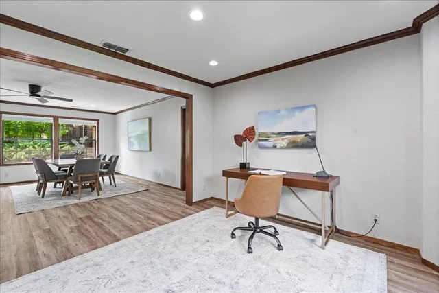 a view of a livingroom with furniture and a window
