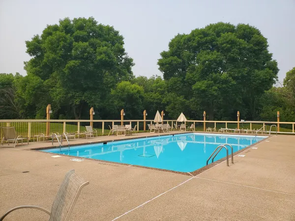 a view of a swimming pool with lounge chairs