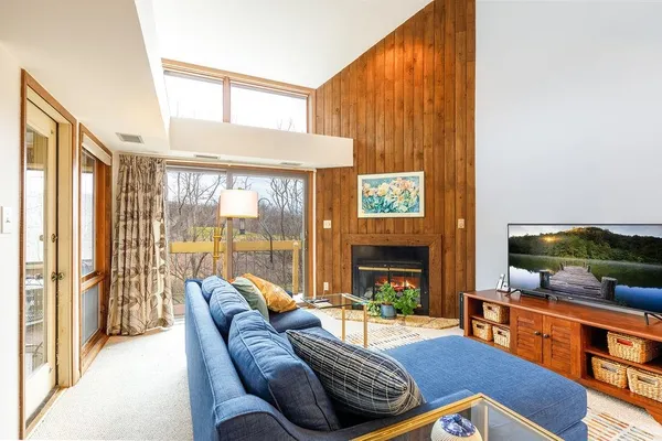 a living room with furniture tv and a large window