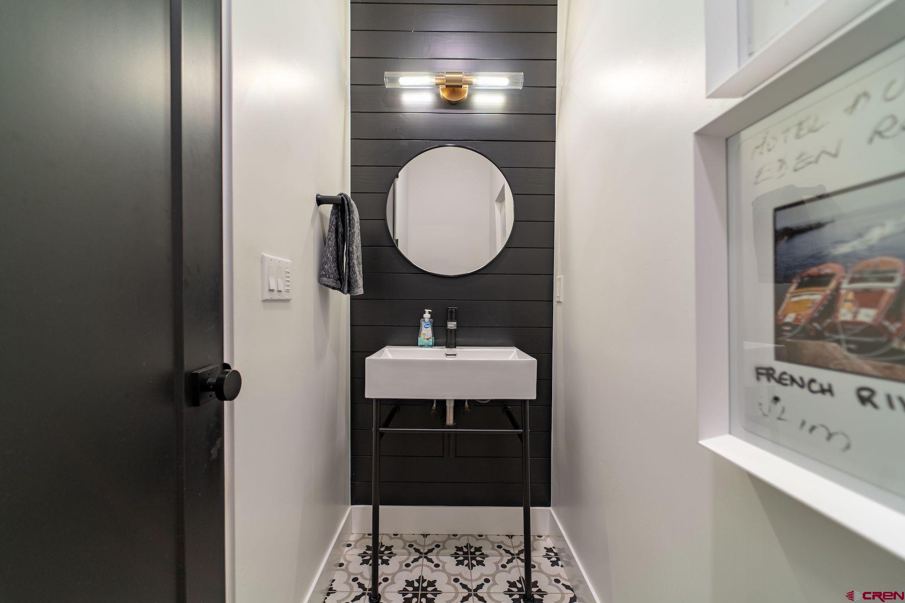 46 Bell Flower Court Durango, CO 81301 - Photo 22 of 40 a bathroom with a sink a mirror and a light fixture
