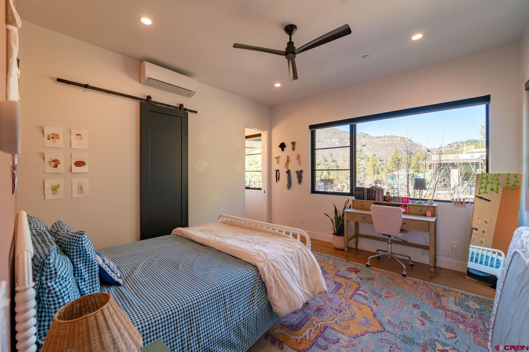 46 Bell Flower Court Durango, CO 81301 - Photo 23 of 40 a bedroom with furniture and a large window