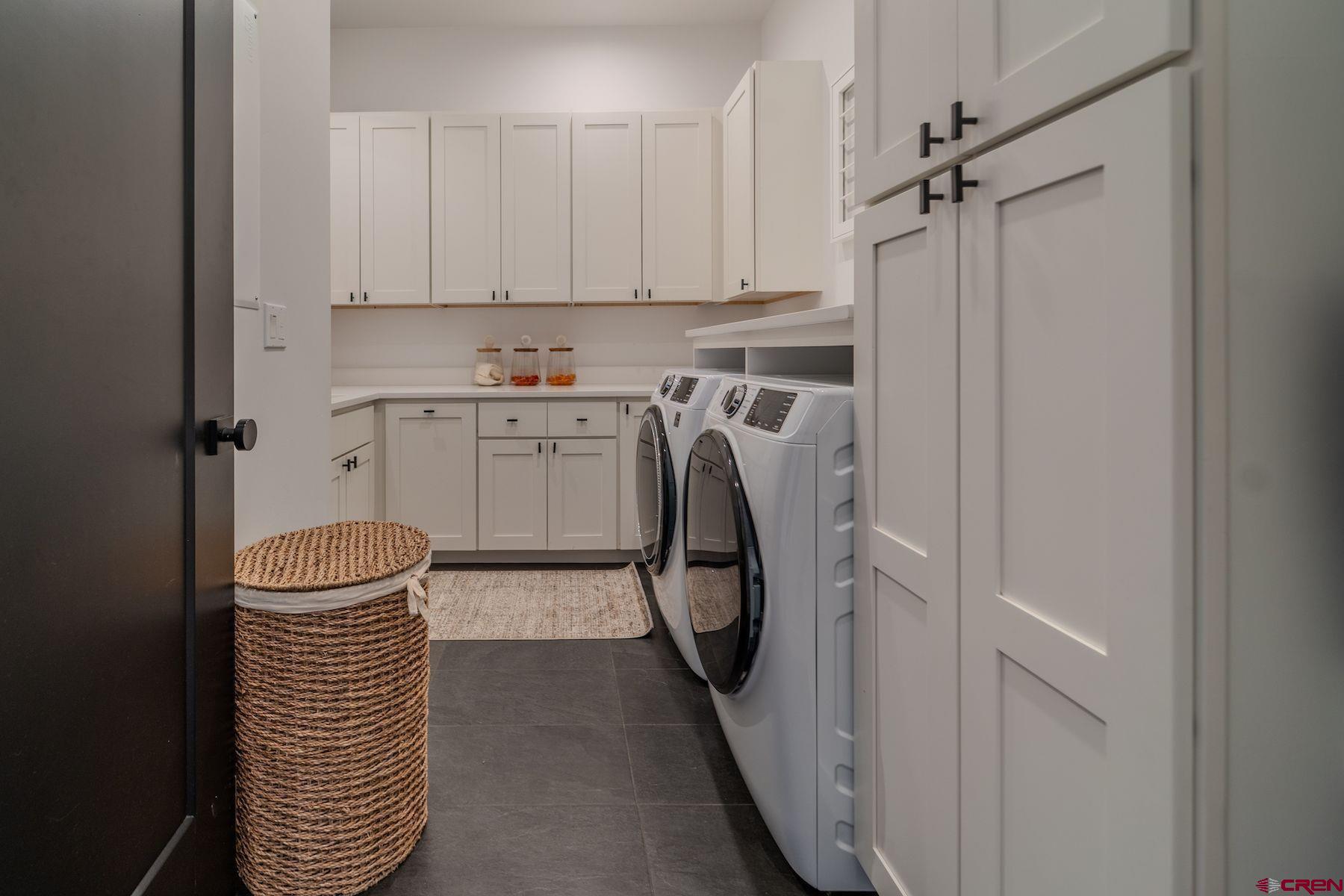 46 Bell Flower Court Durango, CO 81301 - Photo 26 of 40 a utility room with cabinets washer and dryer