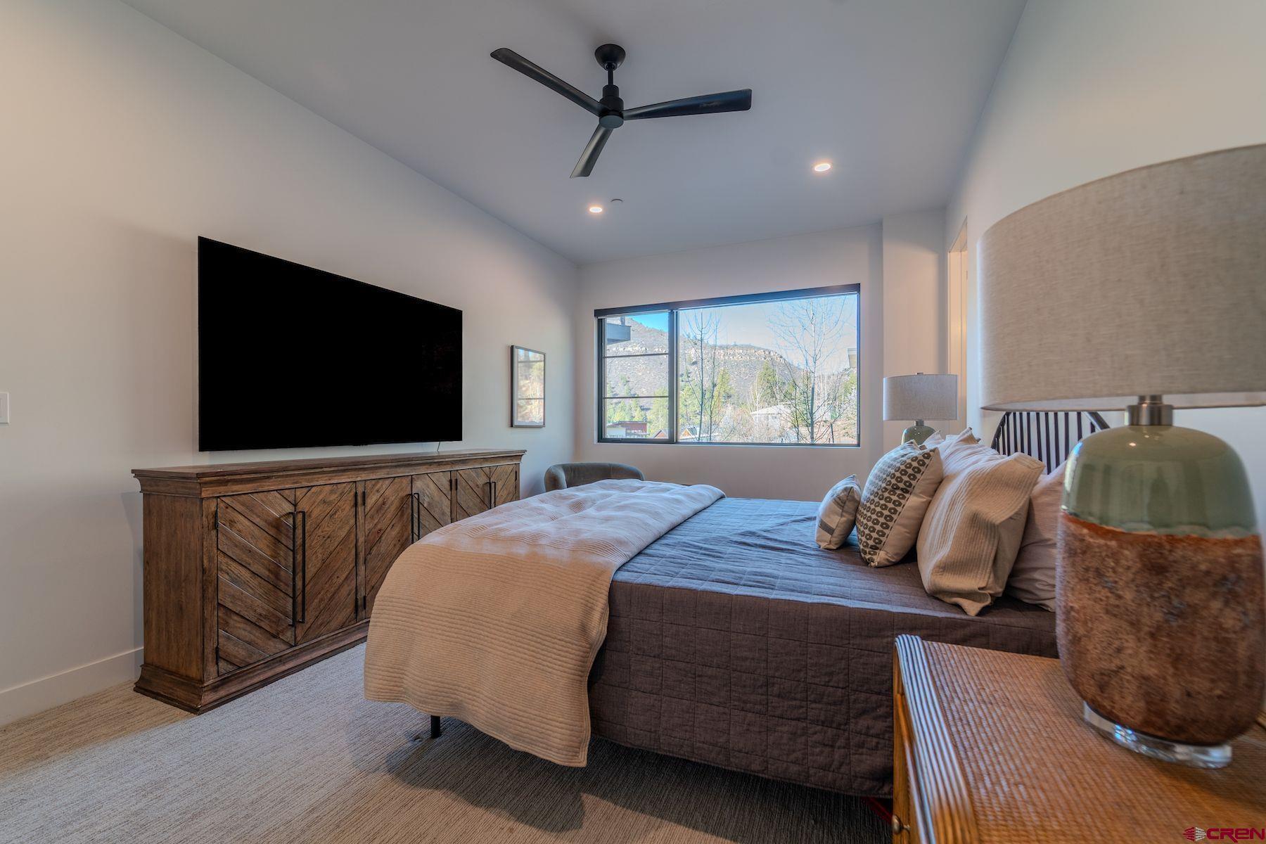 46 Bell Flower Court Durango, CO 81301 - Photo 29 of 40 a bedroom with a bed and a flat screen tv