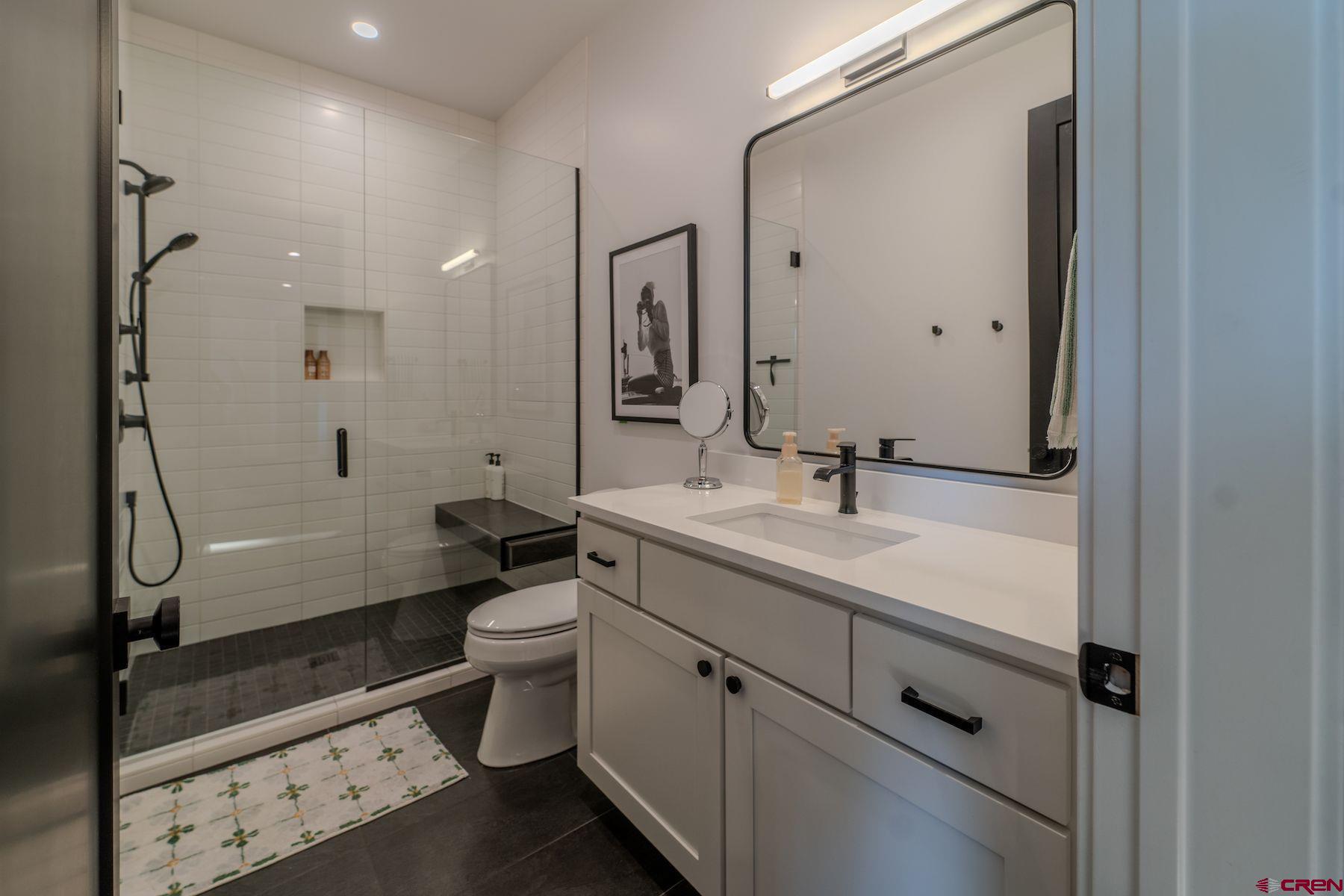 46 Bell Flower Court Durango, CO 81301 - Photo 34 of 40 a bathroom with a double vanity sink toilet and shower