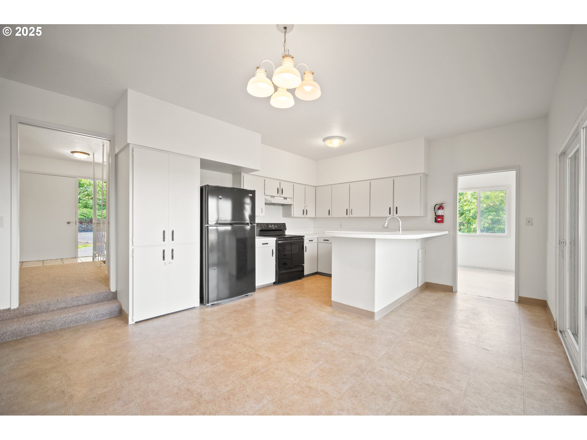 1339 Southwest 27th Court Gresham, OR 97080 - Photo 27 of 41 a large white kitchen with a refrigerator a stove a microwave and cabinets