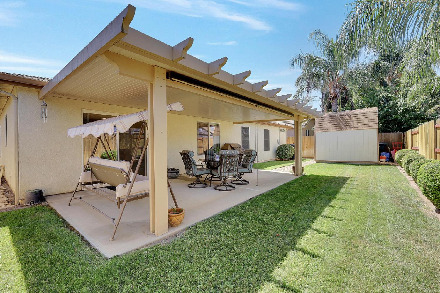 9840 Ellis Way Live Oak, CA 95953 - Photo 37 of 44 a view of a patio with table and chairs potted plants and a palm tree