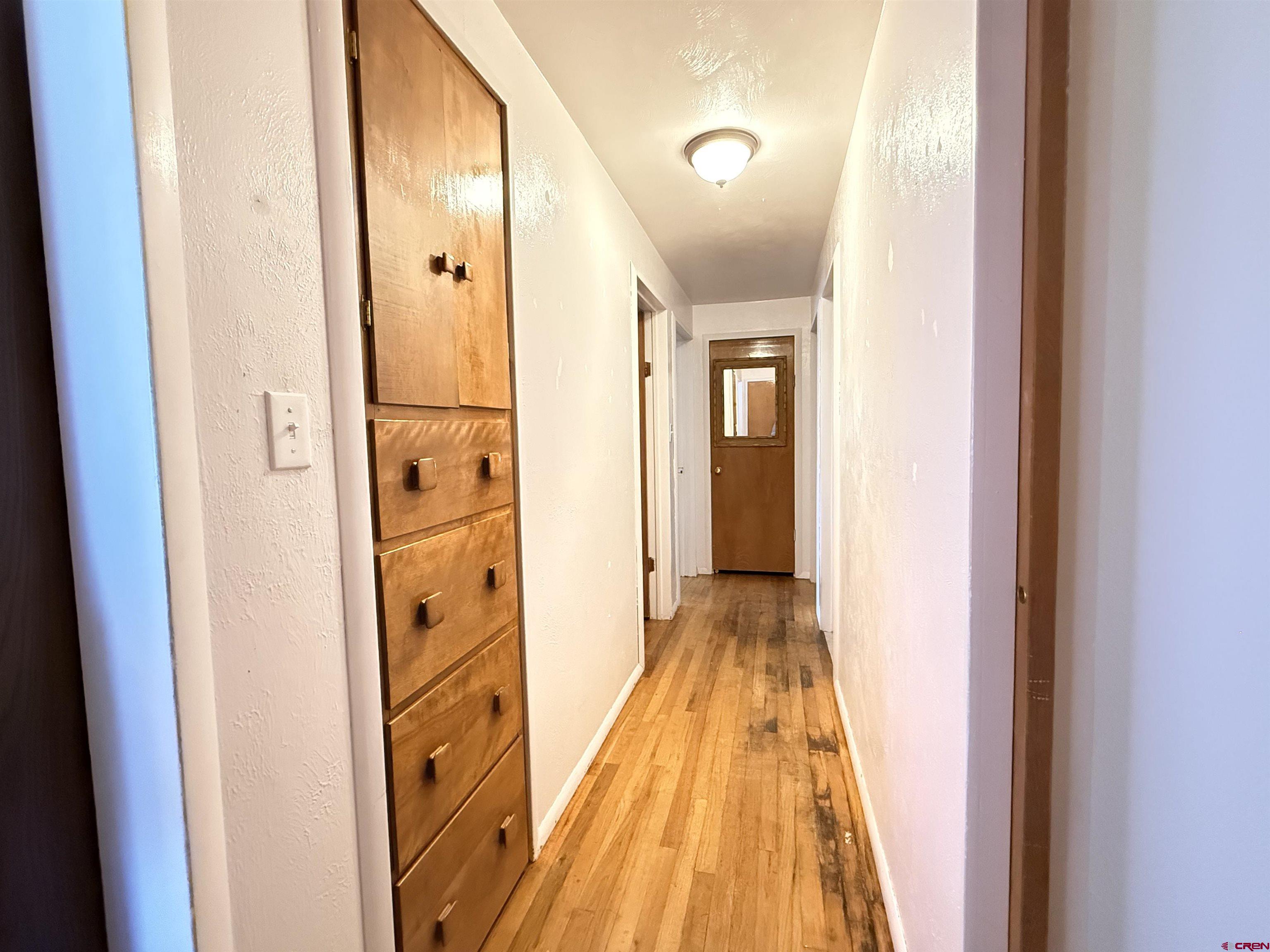 631 A Street Delta, CO 81416 - Photo 16 of 25 a view of a hallway with wooden floor and a bathroom