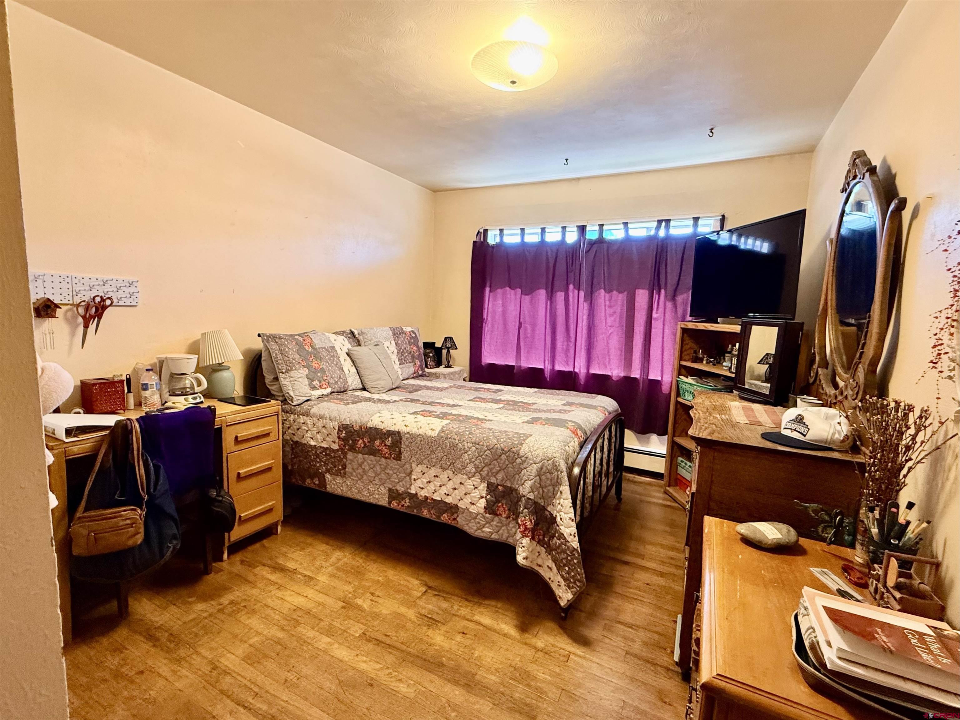 631 A Street Delta, CO 81416 - Photo 20 of 25 a bedroom with a bed and a flat screen tv