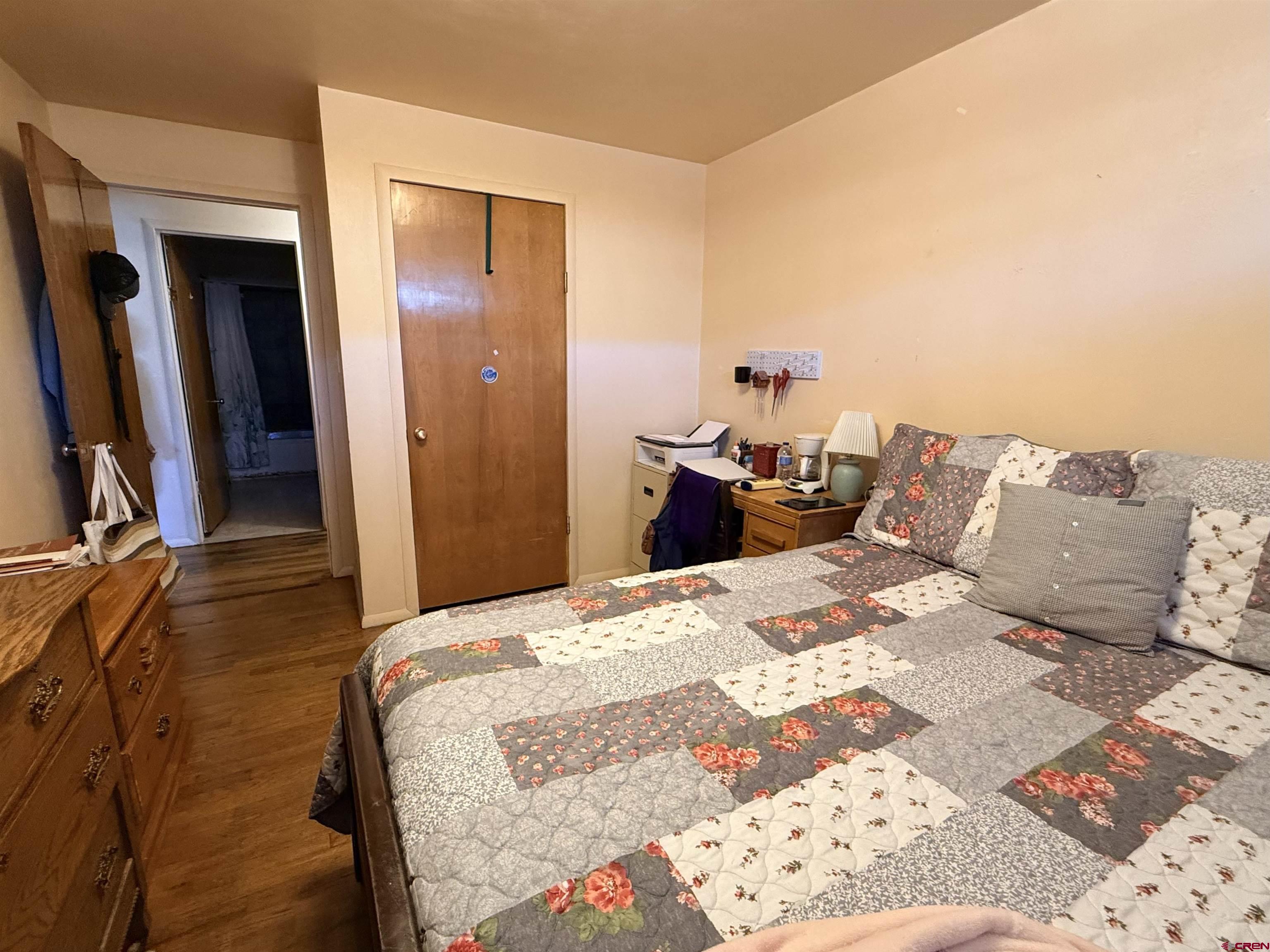 631 A Street Delta, CO 81416 - Photo 21 of 25 a bedroom with a bed and wooden floor