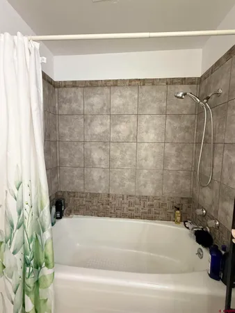 a bathroom with a bathtub and shower