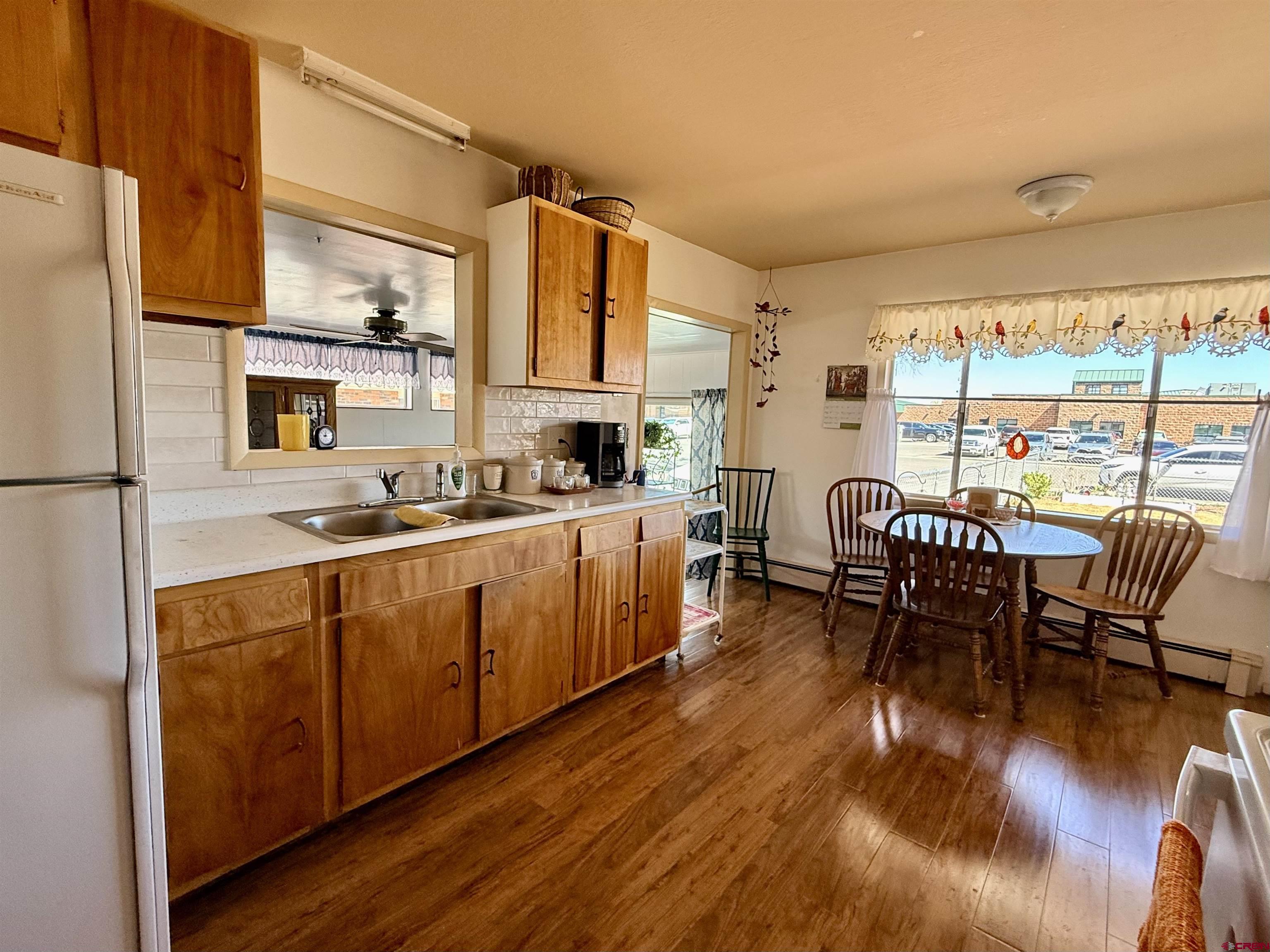 631 A Street Delta, CO 81416 - Photo 6 of 25 a kitchen with stainless steel appliances granite countertop a table chairs and a refrigerator