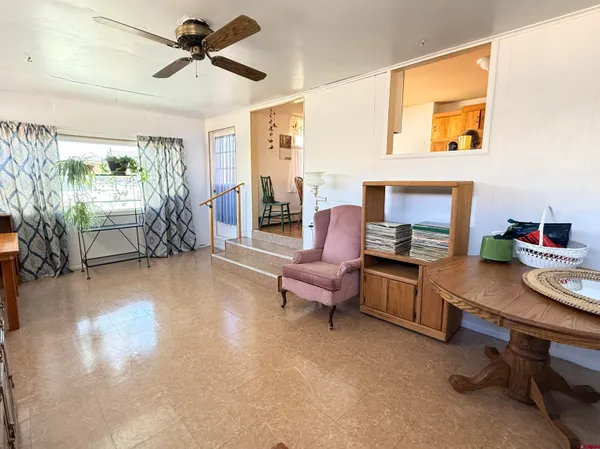 a work room with furniture and a wooden floor