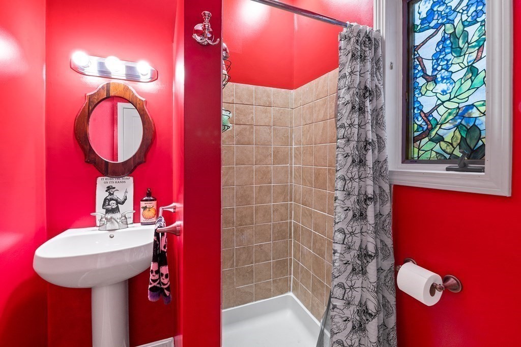 868 Main Street Reading, MA 01867 - Photo 13 of 32 a bathroom with a sink a mirror and a toilet
