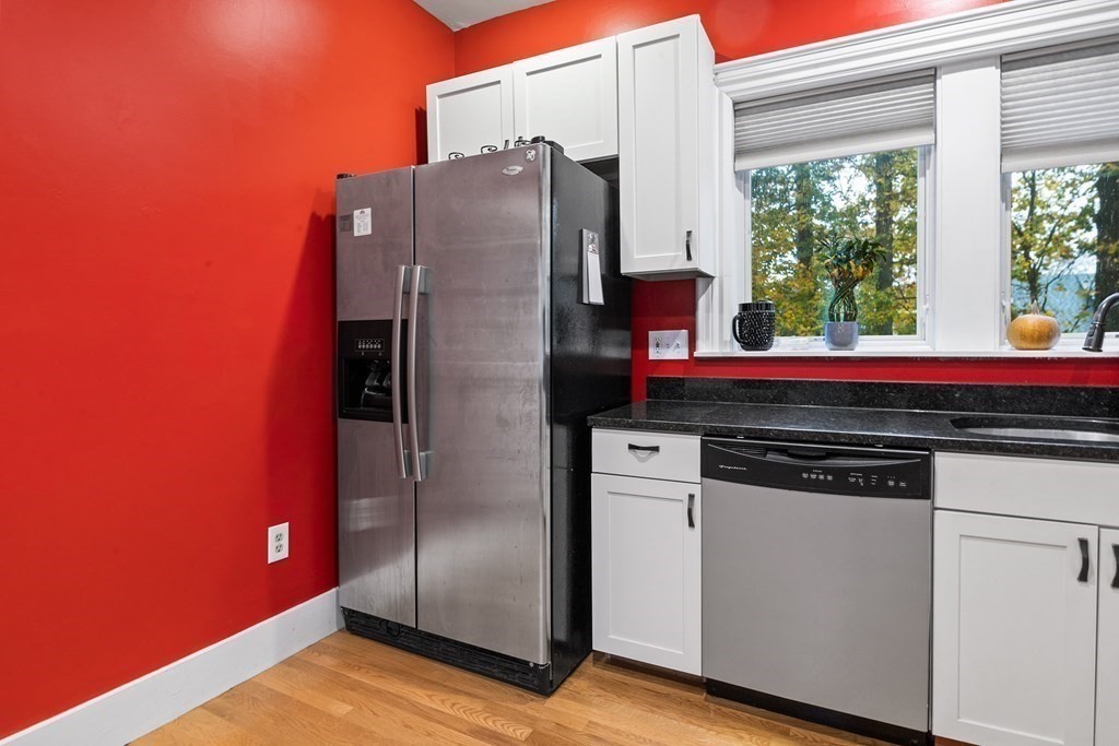 868 Main Street Reading, MA 01867 - Photo 8 of 32 a kitchen with stainless steel appliances granite countertop a refrigerator and a sink