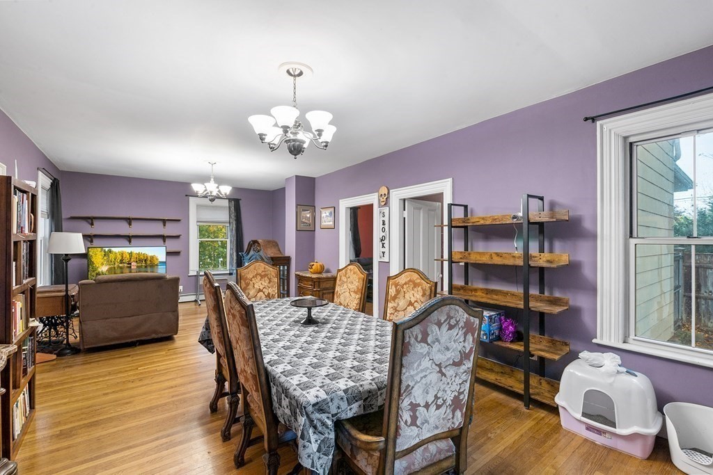 868 Main Street Reading, MA 01867 - Photo 10 of 32 a view of a dining room with furniture a chandelier and wooden floor