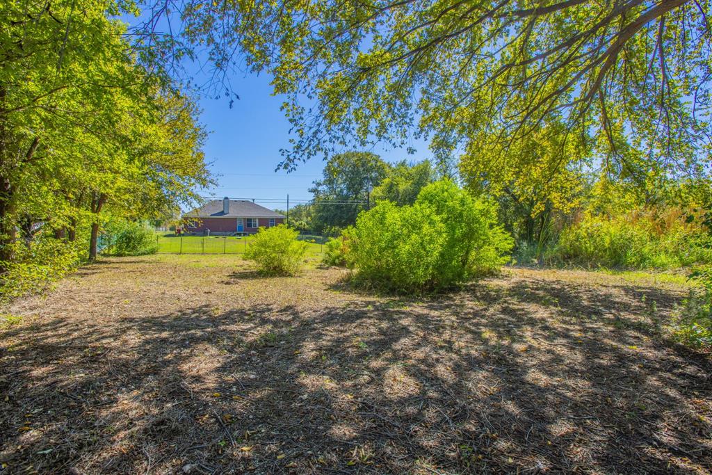 4930 Spring Valley Road Lorena, TX 76655 - Photo 30 of 34 Expansive lot featuring mature trees, established foliage, and partial fencing
