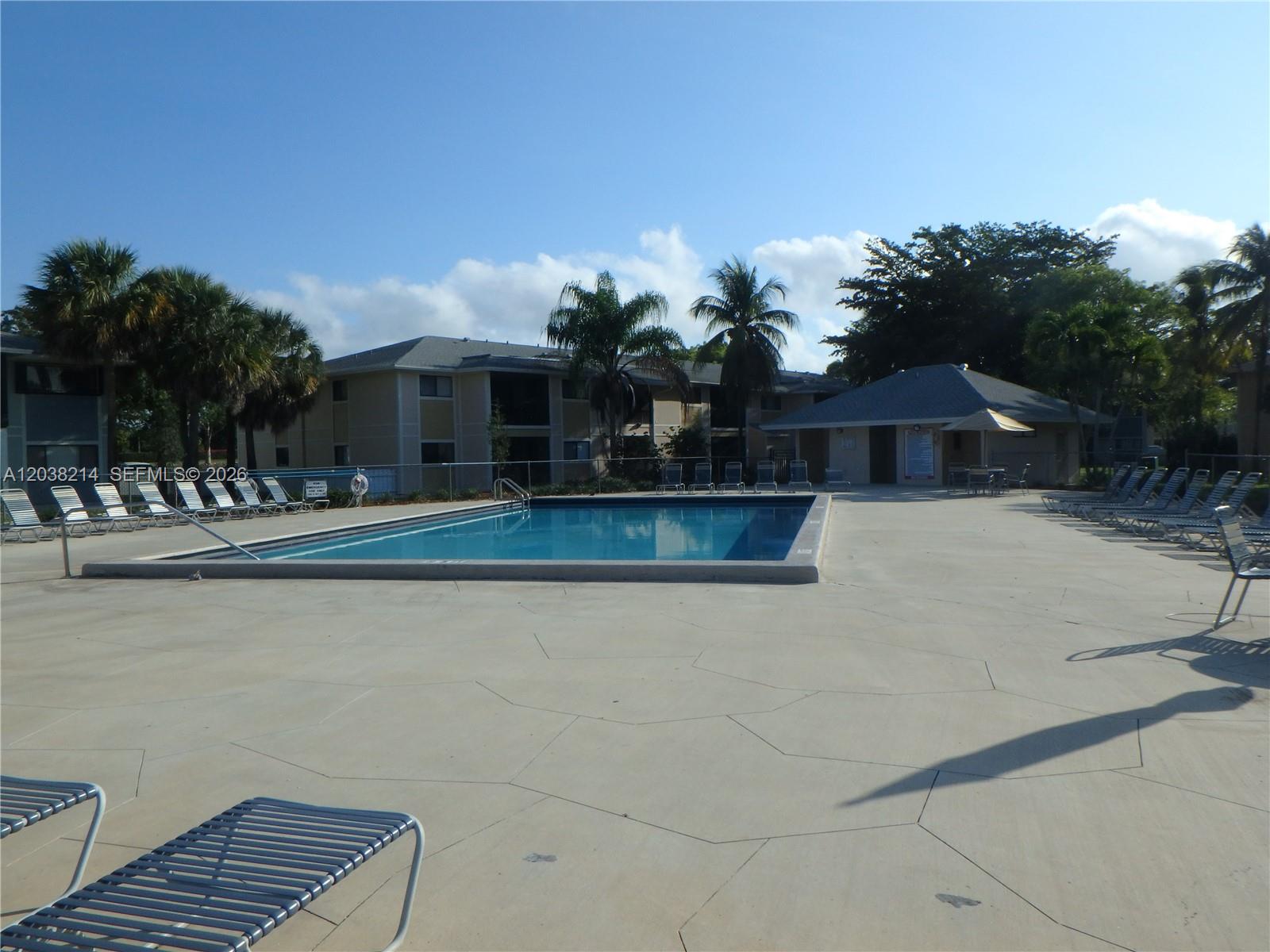 9727 Hammocks Boulevard, Unit 101D Miami, FL 33196 - Photo 2 of 12 a front view of house with yard and trees in the background