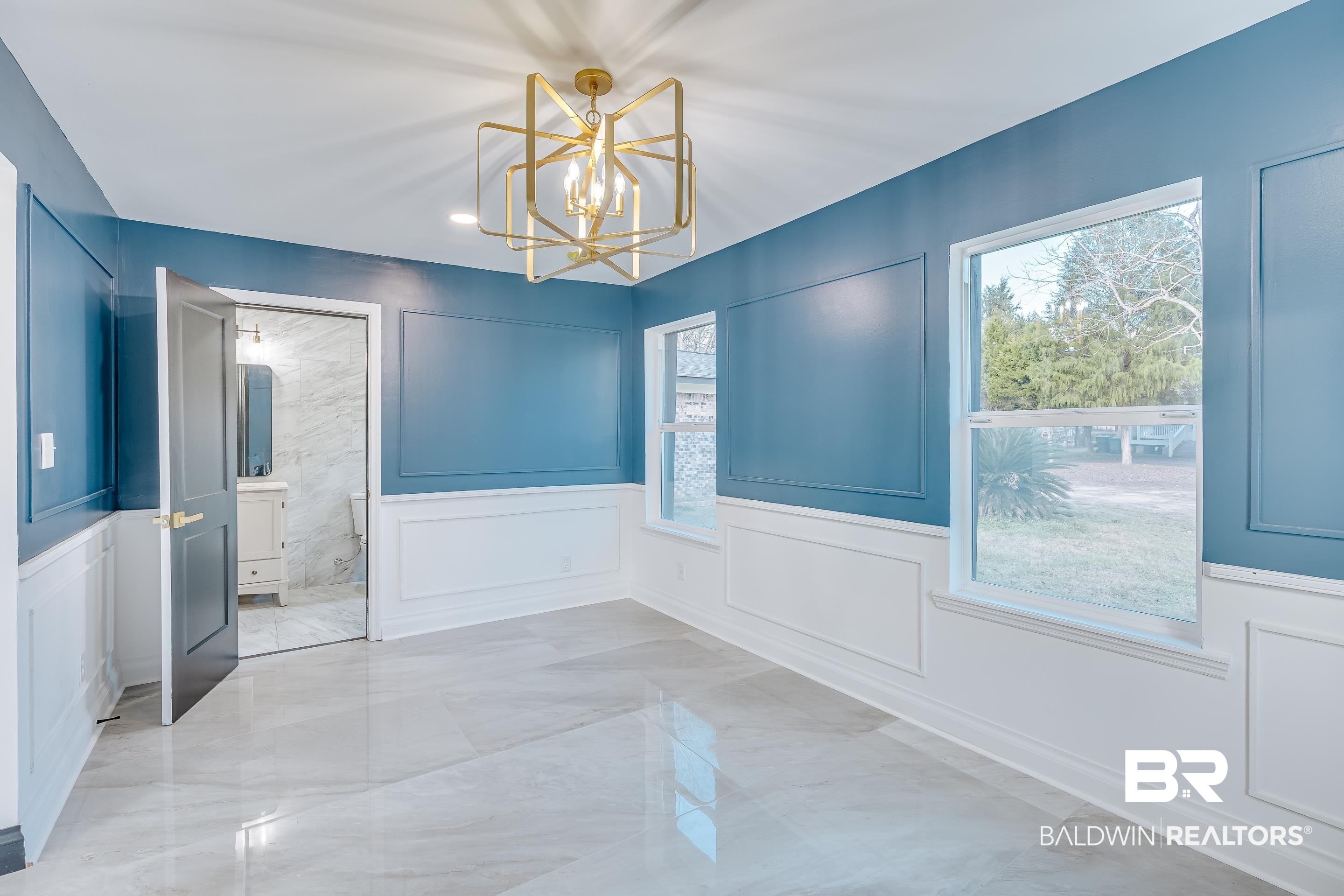 1190 Military Road Mount Vernon, AL 36560 - Photo 13 of 47 Unfurnished dining area featuring a decorative wall, light marble finish floors, a chandelier, and a wainscoted wall
