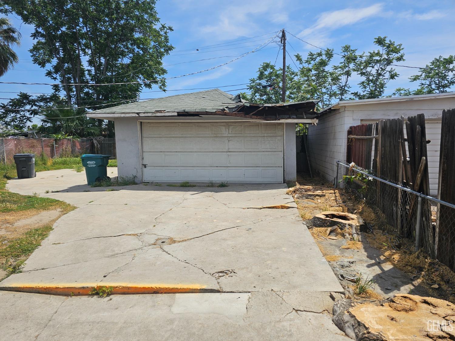 Undisclosed Address Bakersfield, CA 93304 - Photo 6 of 15 a front view of a house with a garage