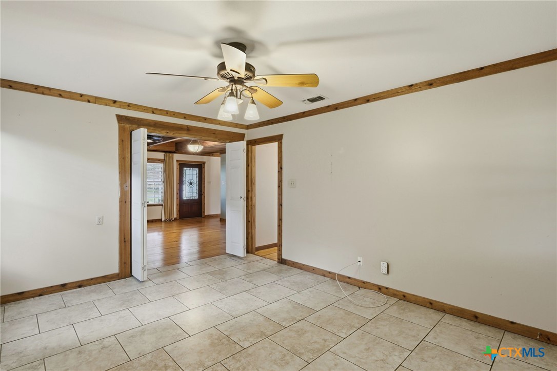 903 Summit Street Round Rock, TX 78664 - Photo 9 of 38 Flex room and be used as another spacious bedroom #4 or Office space, music room, playroom or more. Door leads out to the back covered porch and the expansive back yard.